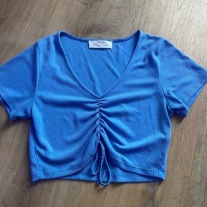 Adorable blue cropped top. Cute tie strings. Good quality. Ribbed material.